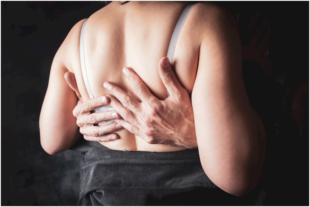 Hands embracing a woman