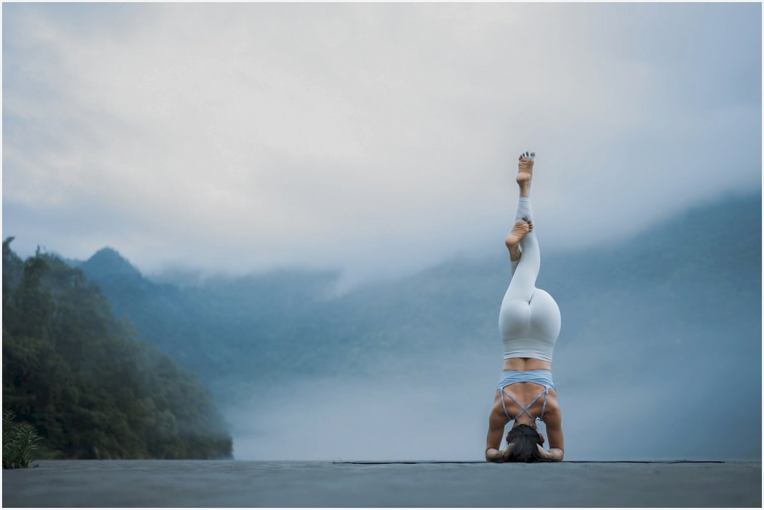 A person doing a handstand on a road