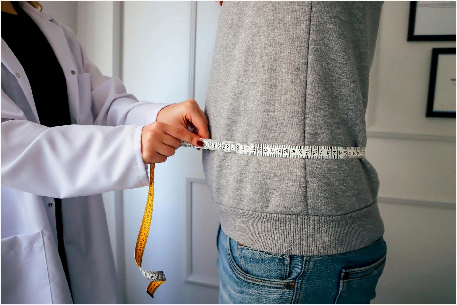 A nutritionist measuring a patient
