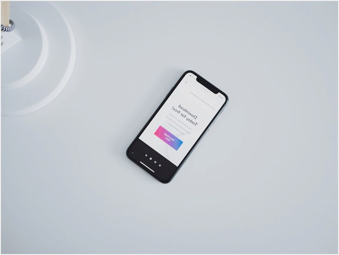 turned on iPhone X on white surface