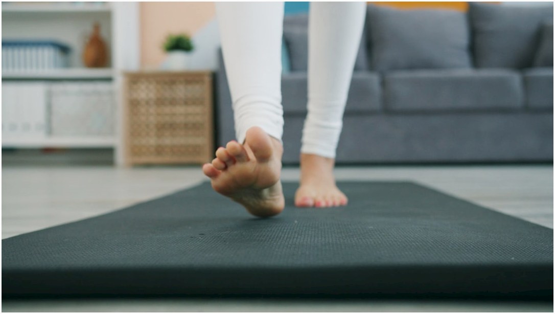 Bare feet walking on a yoga mat