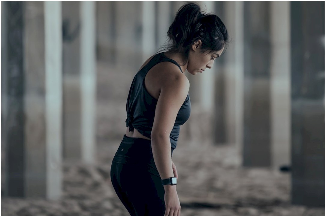 woman in blue tank top and black leggings