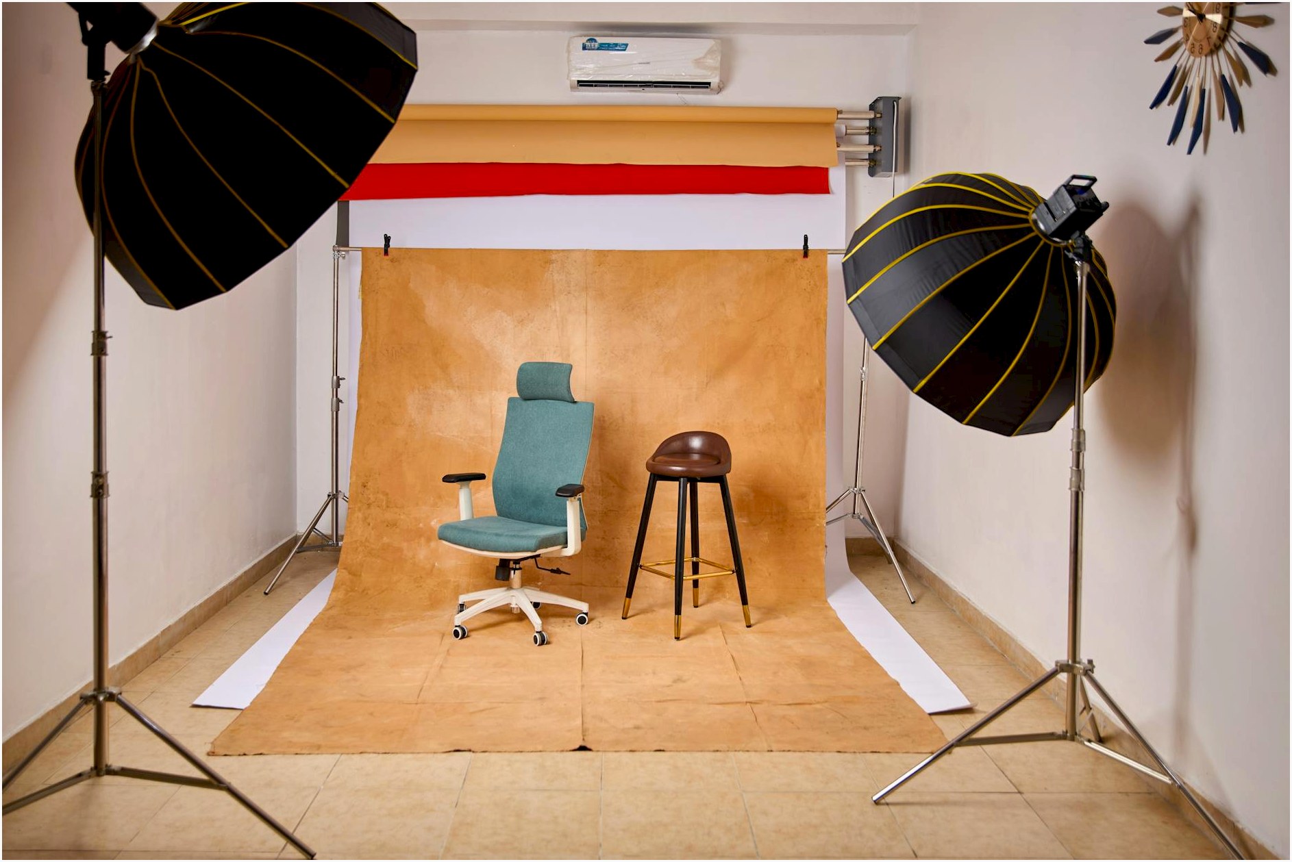 Stylish photo studio featuring lighting equipment and chairs for content creation.