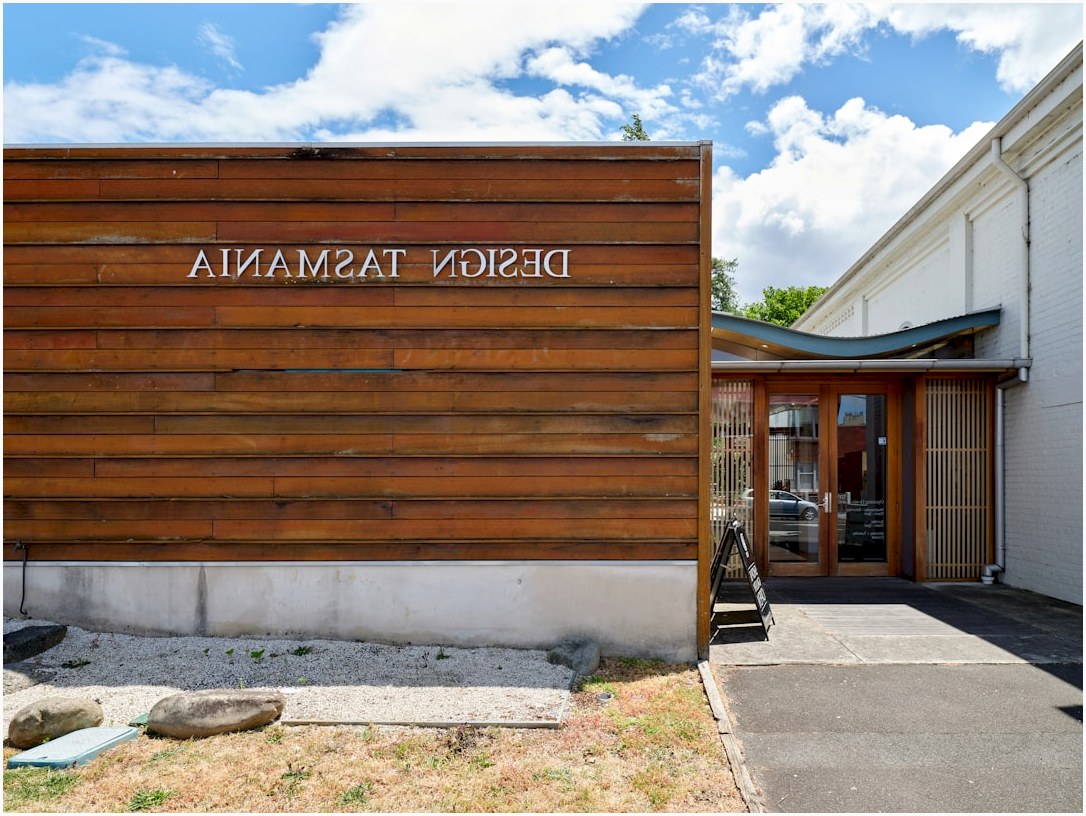 Modern building entrance with "design tasmania" sign.