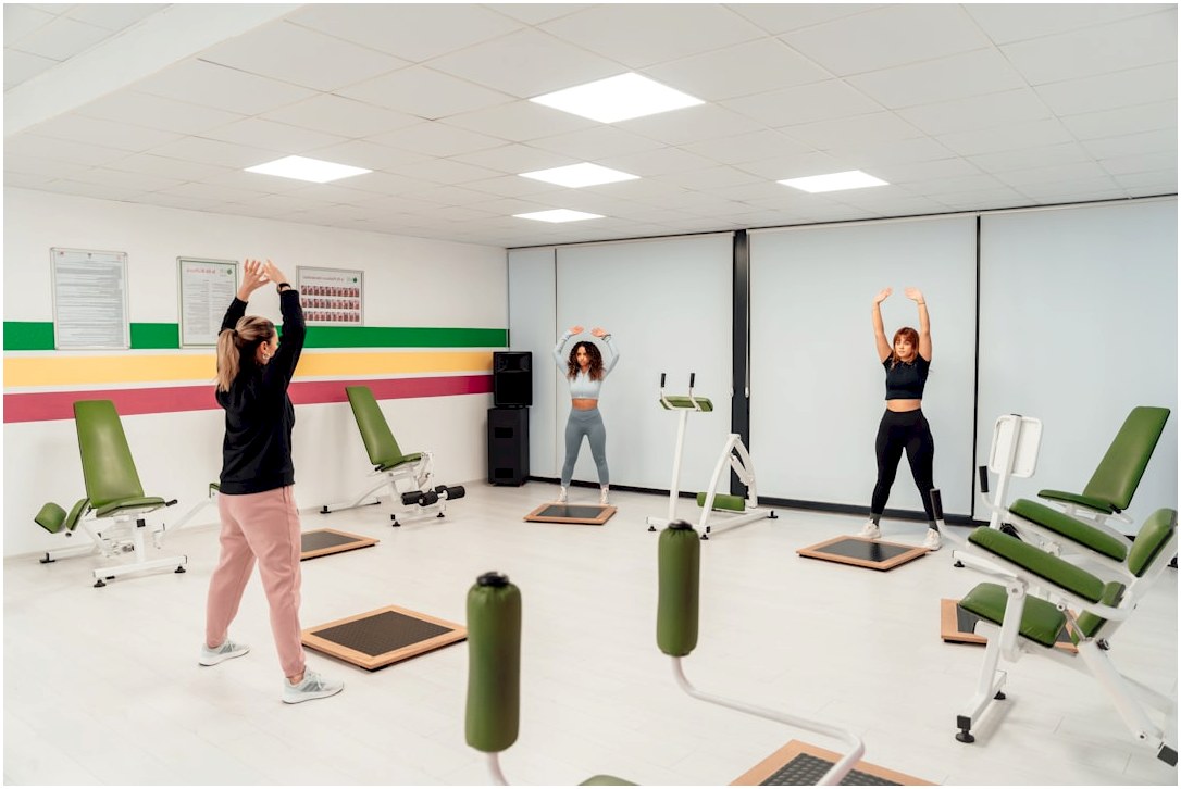 a group of people doing exercises in a gym