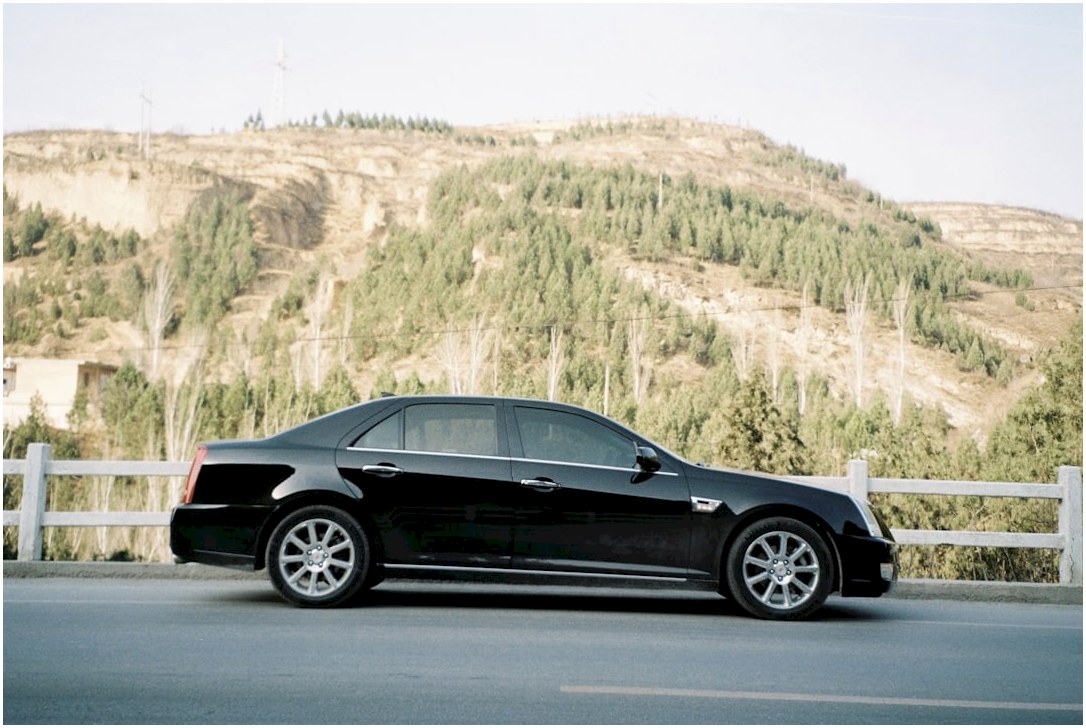 black coupe on gray asphalt road during daytime
