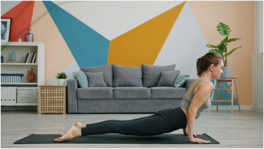 Woman doing upward-facing dog yoga pose on mat