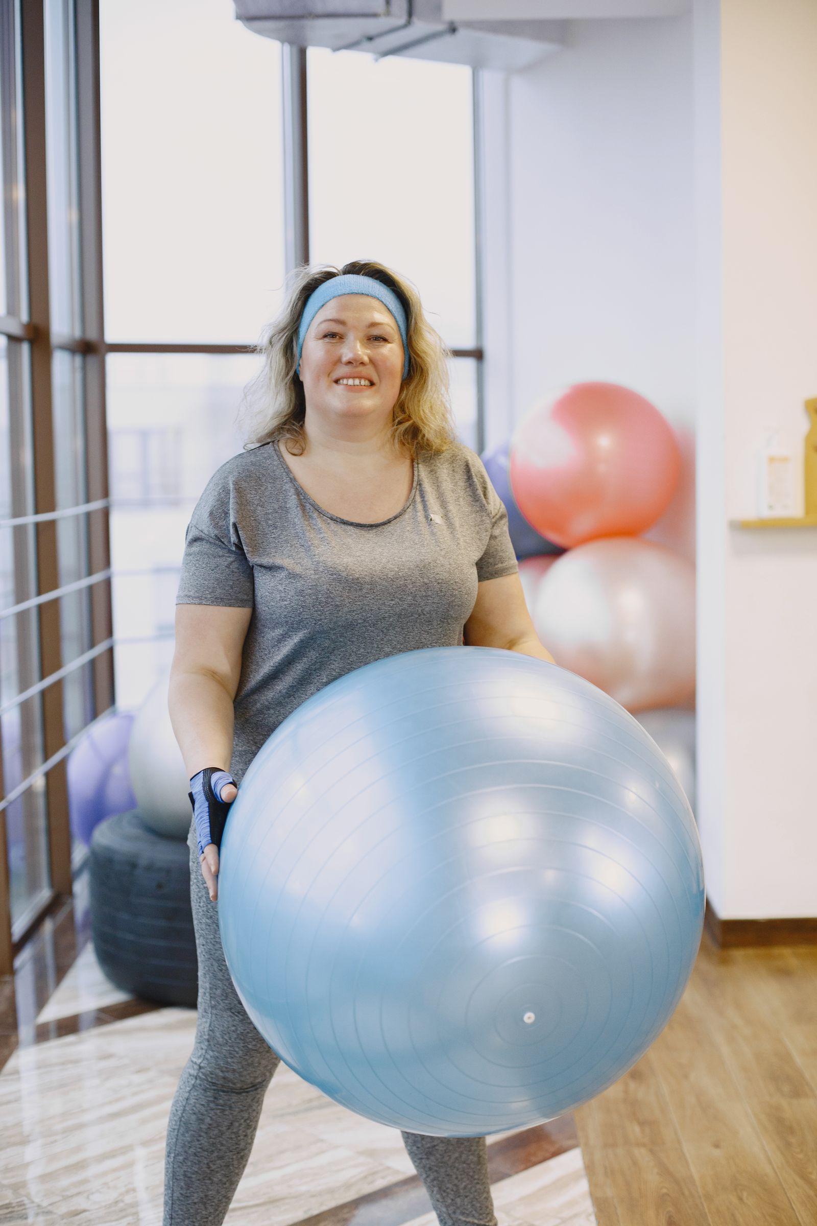 Pessoa segurando uma bola de exercício; imagem ilustrativa para a escolha de bola de Pilates.